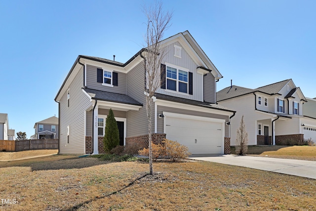 traditional home with driveway, fence, board and batten siding, an attached garage, and brick siding