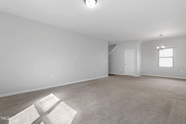 empty room featuring baseboards, carpet, and a chandelier