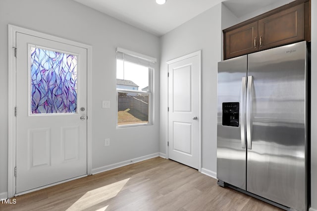 interior space with baseboards and light wood-style floors