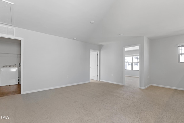 empty room featuring washer / dryer, a healthy amount of sunlight, visible vents, and carpet floors