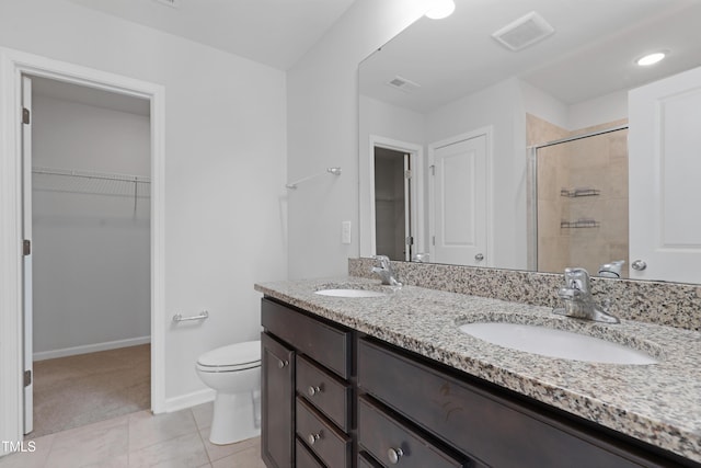 full bath with a spacious closet, visible vents, a shower stall, and a sink