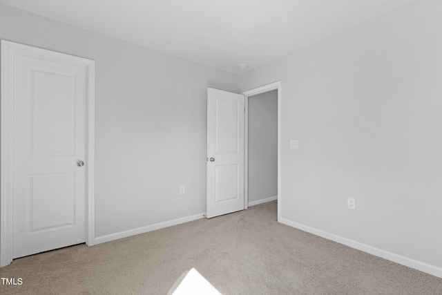 unfurnished bedroom with carpet and baseboards