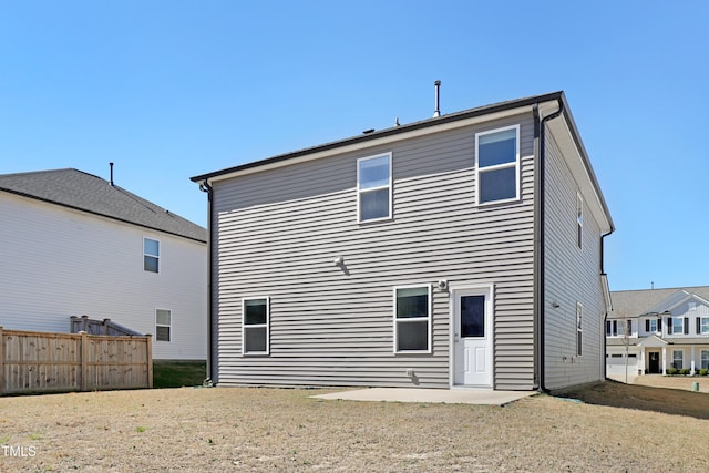 back of property featuring fence