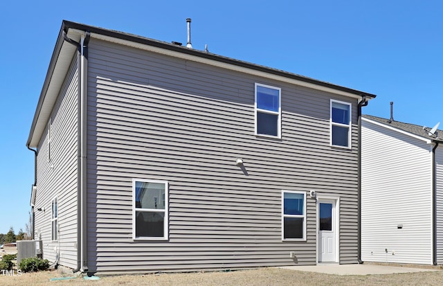 rear view of property featuring central AC