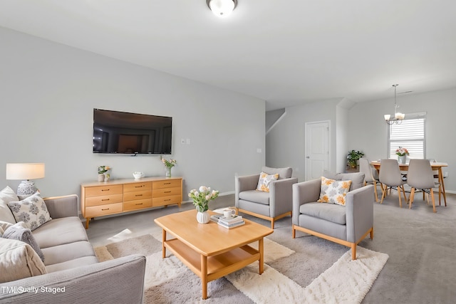 living room with a notable chandelier and light carpet