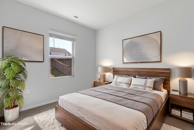 carpeted bedroom with baseboards and visible vents