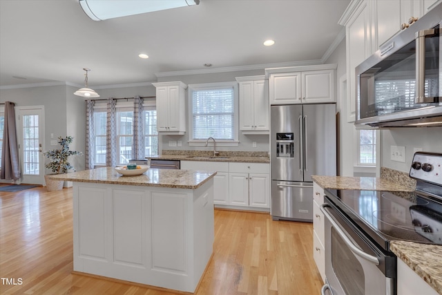 kitchen with white cabinetry, crown molding, light wood-style floors, and stainless steel appliances