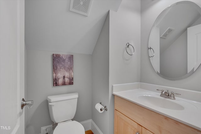 half bath featuring vanity, vaulted ceiling, toilet, and visible vents