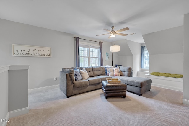 living room featuring baseboards, a ceiling fan, a healthy amount of sunlight, and carpet flooring