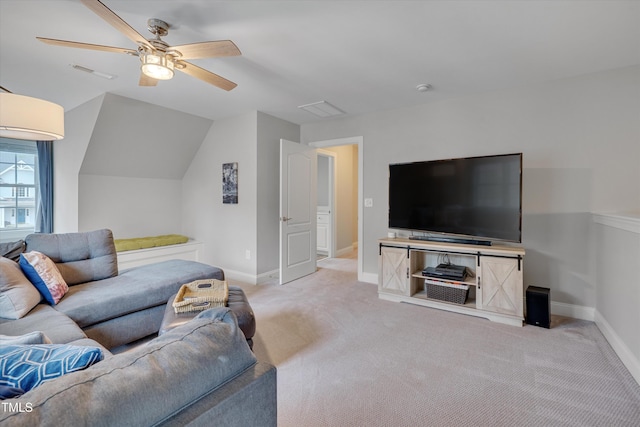 carpeted living area with visible vents, baseboards, ceiling fan, and vaulted ceiling