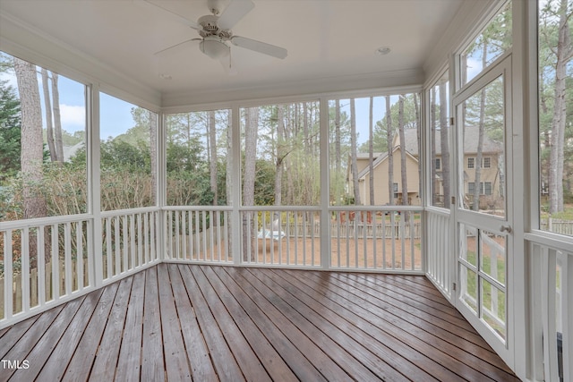 unfurnished sunroom featuring a ceiling fan