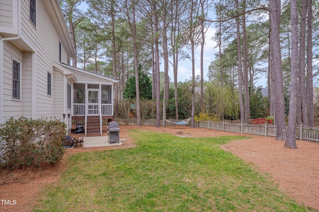 view of yard with a fenced backyard and a sunroom