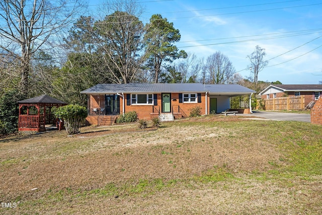 ranch-style house featuring driveway, a gazebo, a front yard, a carport, and brick siding