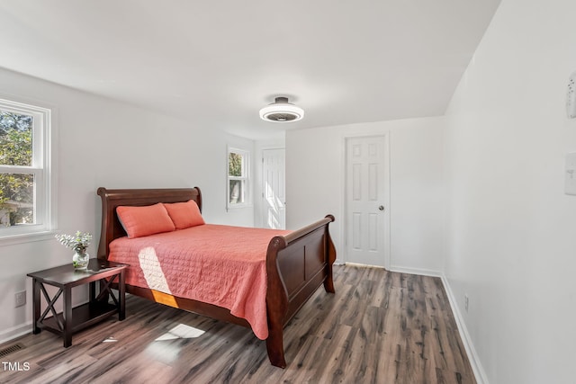 bedroom featuring baseboards and wood finished floors