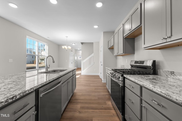 kitchen with gray cabinets, stainless steel appliances, and a sink