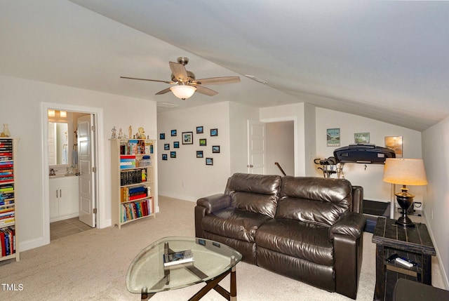 living room with lofted ceiling, carpet flooring, baseboards, and ceiling fan