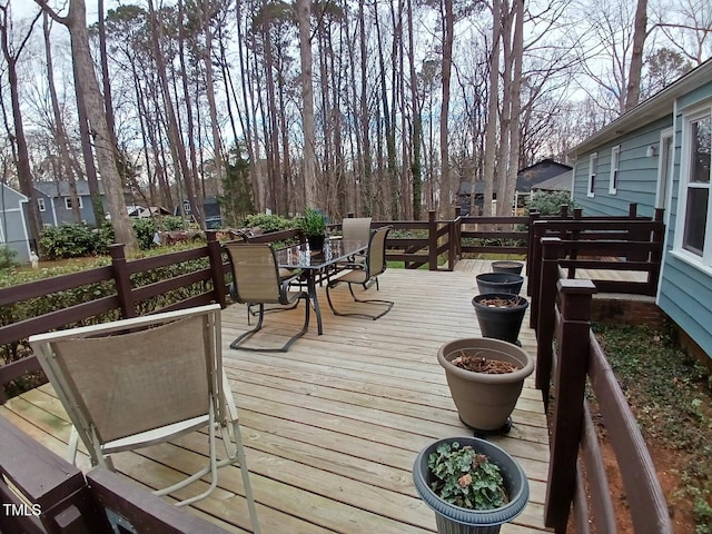 deck with outdoor dining area