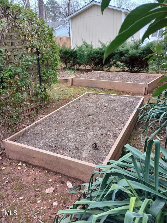 view of yard featuring a vegetable garden and fence