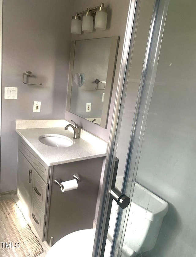 bathroom with vanity and toilet