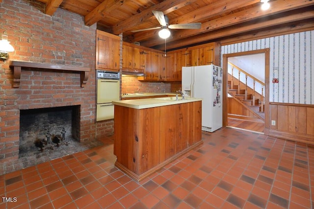 kitchen with beam ceiling, white appliances, wooden ceiling, brown cabinetry, and light countertops