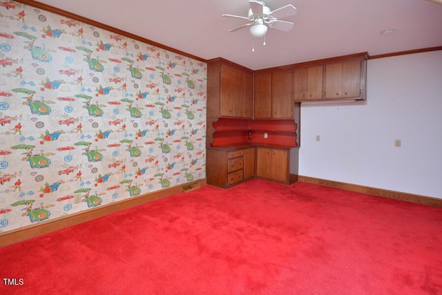 kitchen with brown cabinetry, baseboards, ornamental molding, and carpet flooring