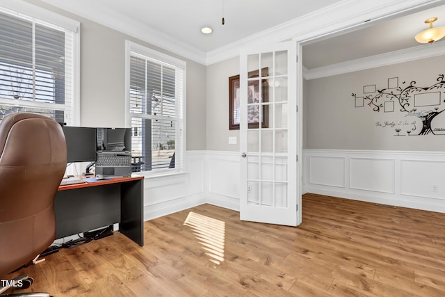 office space featuring light wood-style floors, wainscoting, and ornamental molding