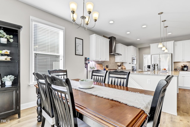 dining area featuring a notable chandelier, recessed lighting, baseboards, and light wood-style floors