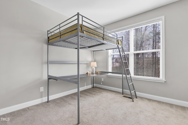 unfurnished bedroom featuring visible vents, carpet, and baseboards