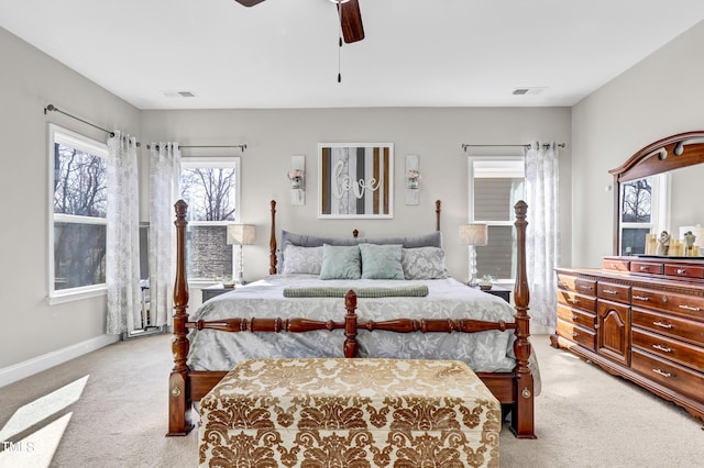 bedroom with light carpet, visible vents, ceiling fan, and baseboards