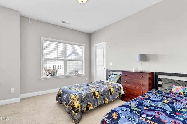 bedroom featuring visible vents, baseboards, attic access, and carpet flooring