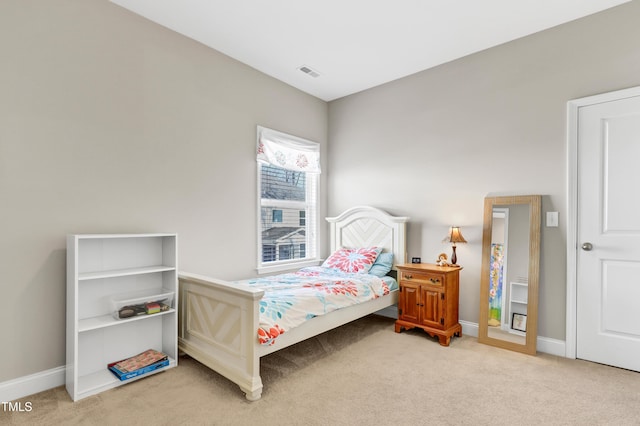 carpeted bedroom with visible vents and baseboards