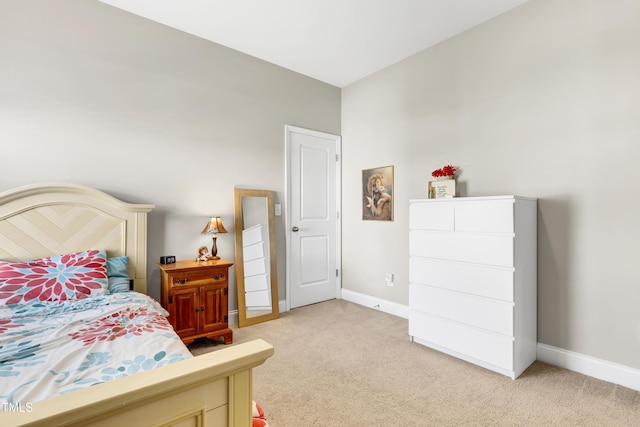 bedroom featuring baseboards and light carpet