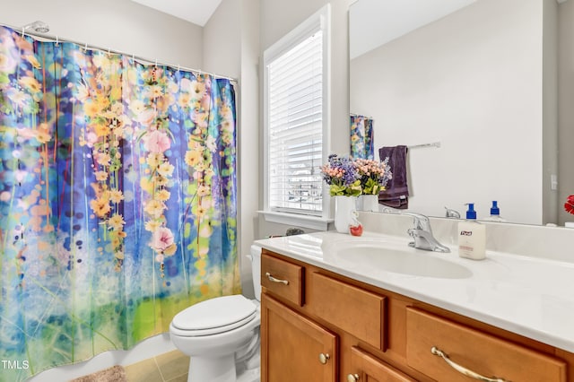 full bathroom featuring vanity, tile patterned floors, and toilet