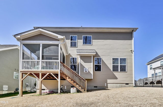 back of house featuring crawl space, stairway, and a sunroom