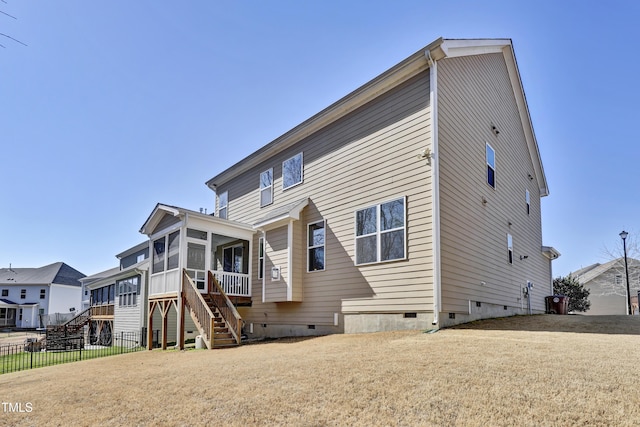 back of house with crawl space, fence, stairs, and a sunroom