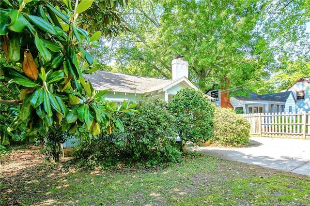 view of yard with driveway and fence