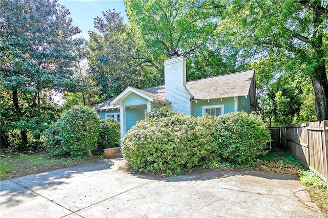 view of front of property featuring fence and a chimney