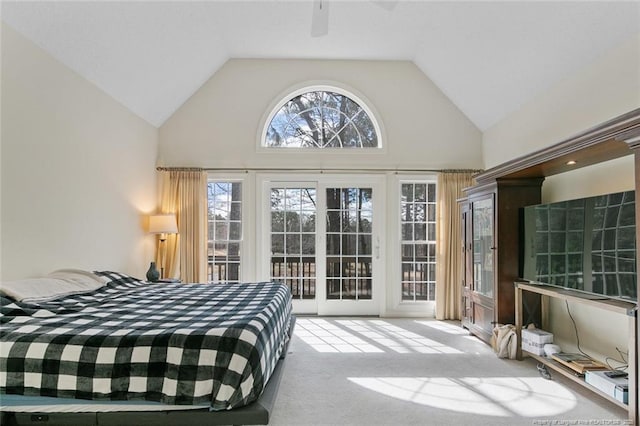 carpeted bedroom with high vaulted ceiling, ceiling fan, and access to outside