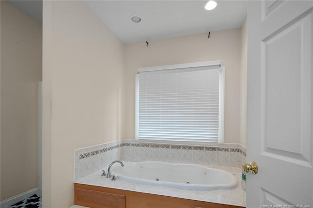 bathroom with a jetted tub and recessed lighting