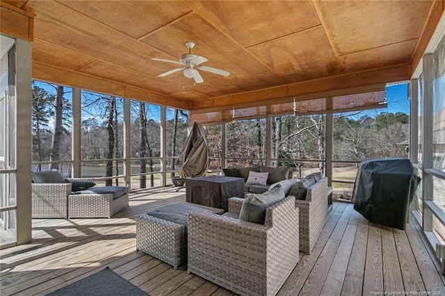 sunroom with wooden ceiling and a ceiling fan