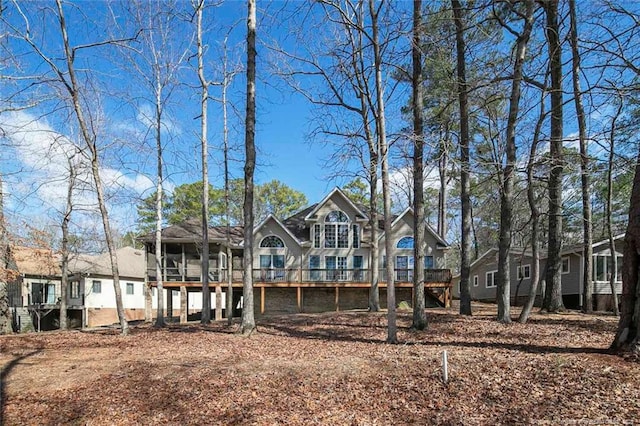 rear view of property featuring a deck and a sunroom