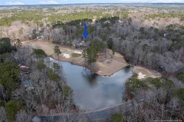 aerial view with a wooded view and a water view