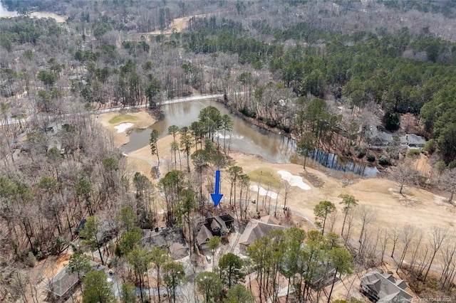 aerial view featuring a wooded view and a water view