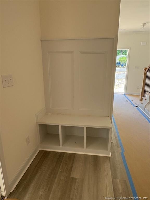 mudroom with wood finished floors and baseboards
