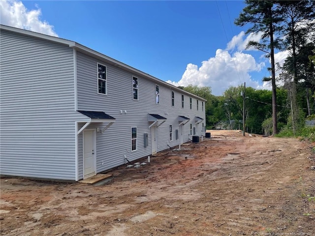 rear view of property featuring central AC unit