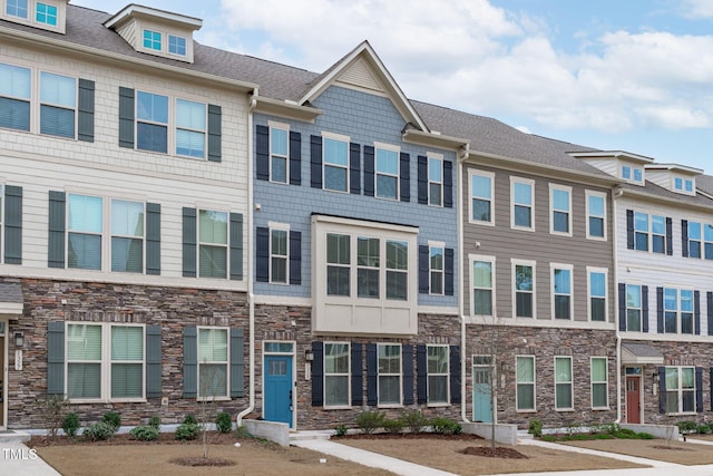 multi unit property featuring stone siding