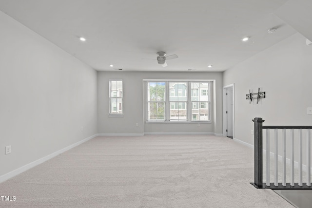 spare room with recessed lighting, baseboards, light colored carpet, and ceiling fan