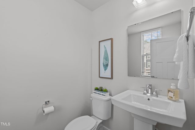 bathroom with toilet and a sink