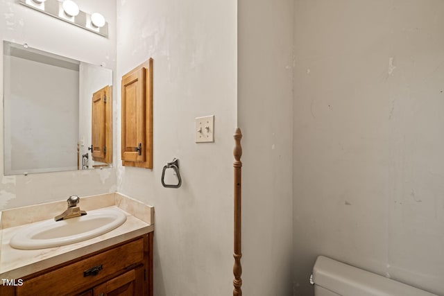 bathroom featuring toilet and vanity