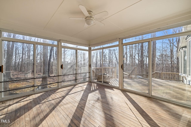 unfurnished sunroom featuring a wealth of natural light and ceiling fan